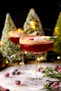 Festive and refreshing! Spiced rum mingles with cranberry, orange liqueur, and an infused maple simple syrup for a cozy and crisp winter cocktail.