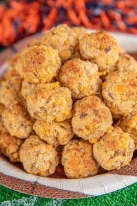 Sausage Pancake Bites - perfect for breakfast, lunch, dinner or parties! Can make in advance and freeze unbaked for later. Only 4 ingredients - sausage, cheese, maple syrup and pancake mix. Mix in your KitchenAid stand mixer and they come together in minutes. Serve with syrup and hot sauce. #sausageballs #freezermeal #makeahead #sausage #recipe