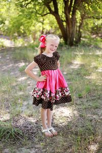 Explore a timeless sewing pattern for an enchanting ruffled peasant dress, perfect for young girls. This pattern showcases a gracefully gathered neckline and cascading layers of ruffles, bestowing a regal allure fit for a genuine princess.