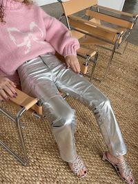 The hyper-stylish Cindy Trouser is a dazzling silver pant made of faux leather, boasting a high waist, timeless slim fit, and five convenient pockets. Details The Cindy Trouser is a stunning silver faux leather pant featuring a high rise, classic slim leg, and five pockets.Shell: 100% Recycled Polyester with polyuretha