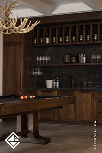 With its captivating, masculine vibe, this rustic rec room bar is perfect for pool games and Friday night fun. Illuminated wine cubicles, a panelled wine fridge, and a floating shelf with stemware rack storage create the ideal setting for effortless entertaining.🎱 Here’s to great design and even better moments! . . . #ChervinKitchen #CustomBarStorage #RusticHomeBar #StemwareStorage #WineDisplay #BarDesignInspiration #LuxuryEntertaining #ModernRustic #CottageDesign #ProjectMargaritaMansion