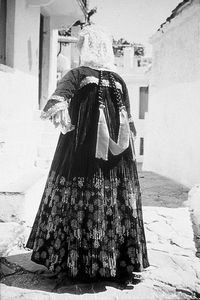 The bridal costume of Skopelos is called “foustana” or “stofa” after the long, richly pleated outer sleeveless dress, which is made of 16 metres of black silk satin. There are four underdresses: the small and the large “f’stana” (a sort of crinoline), the “malakofi”, and lastly the “kolovoli”, identical in shape to the outer foustana. Skopelos, 1995. Dimitris & Anthi Valsamakis' Collection