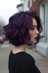 Short, textured waves in intense midnight purple are perfect for a daring and striking look. This hairstyle is ideal for those who want to showcase their bold style with a vibrant and dramatic color.