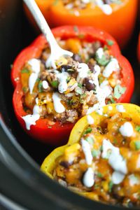 Slow Cooker Stuffed Peppers - Hearty, protein/fiber loaded peppers packed with so much flavor - and it's all made in the crockpot. Easy and effortless!