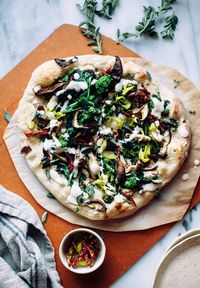 A spicy, vegan white pizza with creamy, dairy-free truffle sauce is the perfect match for a crisped up broccoli rabe, shiitake, and sundried tomato topping.