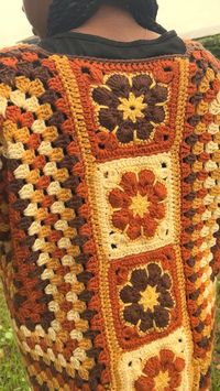 This is a crochet hexagon cardigan that is fall colored with African flower, granny squares