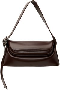 Buffed leather shoulder bag in brown. · Adjustable shoulder strap · Logo stamp at back face · Hinged foldover closure · Patch pocket at interior · Cotton canvas lining · Logo-engraved silver-tone hardware · H5.5 x W11.75 x D3 Supplier color: Choco brown