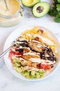 Inspired by Cafe Yumm, our Chicken Burrito Yumm Bowls put our Copycat Yumm Sauce to delicious use! These rice bowls are topped with fresh veggies and an easy-to-make flavorful chicken, for a healthy, hearty, delicious meal. 