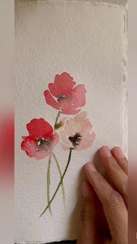 Watercolor Poppies in the Fall  • Poppies have wide petals, these can easily be created by pressing down on the brush and dragging its belly across.  • Create interest by varying the intensity of color.  • Add a thick stem and a black center.