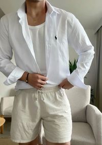 Oversized White Button-Down Shirt for Men - Summer Style Inspiration. Redefine sophistication with this oversized white button-down shirt for men, a versatile staple perfect for summer elegance. Embrace relaxed tailoring with this effortlessly chic piece, designed to add a touch of refinement to any ensemble. The shirt in the photo is a Ralph Lauren, but you can find budget friendly option on Amazon! Click on the image to discover oversized elegance with this Amazon white button-down shirt.