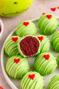 These Grinch Oreo Balls, with a creamy red velvet cheesecake center and sweet chocolate shell, make the perfect holiday dessert. Easy to make and so delicious, these bite-sized treats are sure to steal the show at your next holiday party.