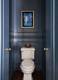 A Parisian inspired water closet awaits guests behind a hidden powder room door from the kitchen.  This rich blue powder room with brass hardware and elegant artwork adds drama to a small, yet memorable space. 

Design by Two Hands Interiors. 

View more of this home on our website. #powderroom 