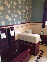 Jodi owns a 1949 ranch style home — and has just finished restoring her stunning vintage maroon and peachy-pink bathroom. She cleaned up and uncovered the gorgeous vintage tiles in her bathroom… found a much needed new toilet that coordinated well with the space… and then pieced together scraps of the bathroom’s original vintage wallpaper …