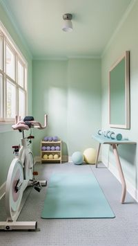 Create an uplifting workout space with this pastel-inspired home gym. 🌸 From mint green walls to lavender dumbbells, the soft, coordinated colors make the room feel fresh and airy. Natural light, motivational prints, and a pastel pink-framed mirror complete this cheerful and welcoming gym. 🌿 #PastelVibes #HomeFitnessGoals