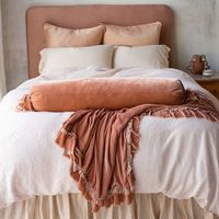 Paloma Shams in Rouge, Bria Pillowcases in Parchment, Austin Duvet Cover in Pearl, Loulah Bolster and Loulah Throw Blanket in Rouge and Paloma Bed Skirt in Pearl.