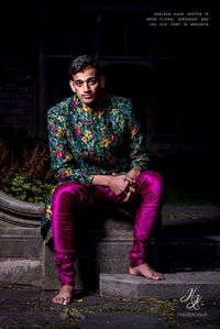 Multicolored tropical florals make up this Sherwani Jacket paired with magenta silk JAG pants.