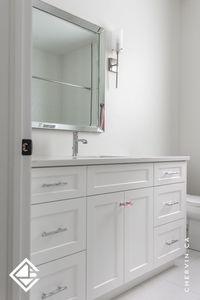 This stunning white bathroom vanity is equipped with a shaker door and polished chrome hardware. Plus an added touch of pretty pink round knobs for the cabinet doors. #KidsBathroom #WhiteBathroom #WhiteVanity #PinkBathroom