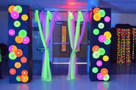 Door entrance made out of cardboard boxes, black paper, and fluorescent paper decor. UV Reactive light fabric from blacklight.com