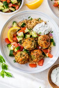 Mediterranean Meatballs made with flavorful ground turkey meatballs served over Israeli couscous and a bright, lemony cucumber tomato salad. #groundturkey #meatballs #healthydinner #weightwatcherdinner #healthyrecipe #airfryer