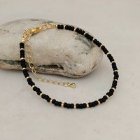 "This black seed bead bracelet has been lovingly made using 3mm matte black glass Miyuki seed beads, highlighted with 2mm Miyuki seed beads in gold or silver.  Threaded on strong stainless steel 7 strand Tiger Tail wire and finished with silver/gold plated wire guardians, a trigger clasp and optional extender chain. Matching necklace available at: https://www.etsy.com/uk/listing/1088803894/black-seed-bead-necklace-handmade-black?click_key=10cac46ea0f8930472efe3246c3de799814e927f%3A1088803894&cli