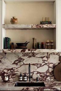 A modern kitchen Prunella marble counter tops and backsplash.