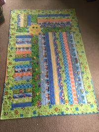 I made this quilt for Megan and Jeremy's baby son. The back was construction equipment because Jeremy works in construction