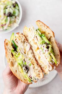 This turkey avocado grinder sandwich has crusty bread layered with turkey, cheese, avocado, and a creamy grinder salad! It's the perfect summer lunch for enjoying poolside!