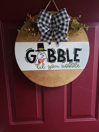 "DOOR HANGER: ⚬ Circles are 16\" x 1/4\" thick Birch Plywood ⚬ Permanent outdoor vinyl used for (most of) the words ⚬ Greenery & Bow are secured with staples ⚬ Signs come ready to hang, with jute rope or wired jute attached w/staples ⚬ Back of the signs are finished, either painted or stained, depending on the front design - perfect for glass doors! ⚬ Signs are sealed with water based polycrilic before & sprayed after completed SHIPPING: ⚬ Handmade in the order in which received (unless in stock