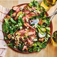 A bright lemon-garlic vinaigrette coats this kale and grilled steak salad while homemade croutons add satisfying crunch.