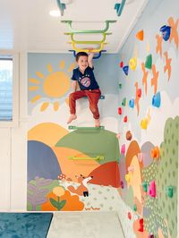 Transform your playroom with this DIY kids climbing wall featuring a fun and colorful mural! This easy tutorial will guide you through building a safe and engaging indoor climbing wall for your toddlers. Perfect for adding excitement and adventure to any playroom, this project also includes monkey bars for extra fun. Discover how to create a vibrant play space that will keep your kids entertained for hours.