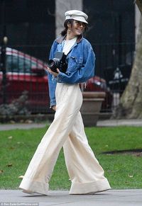 C'est chic: The supermodel exuded Parisian irreverence in a pair of white wie-leg trousers...