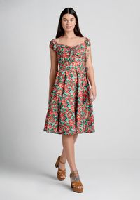 A floral flurry of hand-painted red and yellow blooms in green grass adorably adorn this fit-and-flare dress. Perfect for springtime and beyond, the bodice of this vintage-inspired dress boasts elasticized cap sleeves that offer the option for an off-the shoulder silhouette, and the darling sweetheart neckline features adjustable drawstring detailing at the bust for a custom fit.