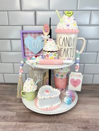 "This listing is for the Candy Hearts Valentine's Day Bundle. This bundle includes the following: -\"Hug\" Mug Topper (Candy Hearts Mug Not Included) -Green \"XOXO\" Mini Mug - topper attached to mini mug (only mug included) -Small Heart Shaped Candy Heart Fake Cake (on a 5\" diameter cake board) -Candy Hearts Cupcake -\"Happy Valentine's Day\" Candy Heart To Go Cup with attached topper -Candy Hearts Beaded Garland with \"Kiss Me\" tag -\"Love\" Wooden Sign -\"Sweet\" Mini Wooden Rolling Pin -Wo