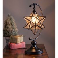 A traditional symbol of Christmas, Plow & Hearth's handmade Moravian Star Table Lamp adds a warm, peaceful glow wherever you display it. Iridescent, clear glass reflects the light beautifully. Metal frame and stand with a black finish. Chandelier bulb not included. | Plow & Hearth 17" Arched Table Lamp 16.5 H x 8.0 W x 8.0 D in / gray / whiteGlass / Metal in Black | 16.5" H X 8" W X 8" D | Wayfair