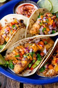 My favourite fish recipe for Summer, these crispy fish tacos are coated in buttermilk and a delicious crispy batter, before being piled into toasted tortillas and topped with fresh pico de gallo.  #tacos #fishtacos #baja #tortillas #mexican #picodegallo