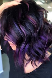 This style surprises with dark magenta highlights peeking through in peekaboo highlight style, adding a hidden layer of vibrancy to the almost black base. Tap the link for more style inspiration!