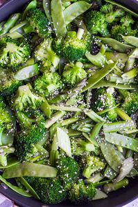 Green stir-fried vegetables in a large pan