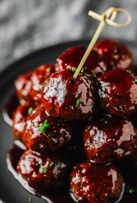 Vegan Grape Jelly Meatballs are easy to make in 20 minutes using 3 simple ingredients. Impossible vegan meatballs are covered in grape jelly and BBQ sauce, then served with toothpicks for holidays, game days, cocktail parties, and more!