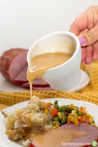 Complete your Christmas dinner with this easy ham gravy from drippings. There’s nothing better than serving your Easter ham with this quick homemade gravy. It really is the best gravy for ham! #HamGravy #HamGravyFromDrippings #HamGravyWithoutDrippings #EasyHamGravy #HamGravyRecipe #HowToMakeHamGravy #HomemadeHamGravy KeyToMyLime.com