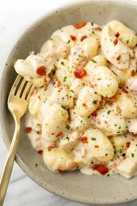 This easy one pan chicken bacon gnocchi recipe is the ultimate comfort food! You will love the pillowy gnocchi, crispy bacon, and tender chicken in a creamy garlic sauce.