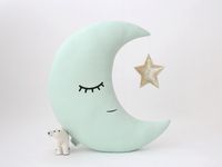 Light mint crescent moon pillow with a crown or star is a magic addition for the baby girl or neutral gender nursery. This charming moon cushion is a perfect baby shower or birthday gift. Dimensions from seam to seam - 38 cm x20 cm (15''x8'') without crown. Materials: - OEKO-TEX 100% cotton on the both sides - Hypoallergenic recycled poly filling insert - Crown made with glitter cotton fabric Care: - Delicate machine wash at 30C with similar colors. - Do not tumble dry. - Do not bleach. - After