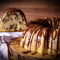 This easy Chocolate Chip Bundt Cake with Peanut Butter Fudge Icing is extra soft and fluffy, and the perfect balance of chocolate to buttery cake. #cake #chocolate #chocolatechip #bundt #bundtcake #easycake | ofbatteranddough.com