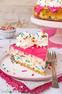 Funfetti Cheesecake - this creamy cheesecake is loaded with colorful sprinkles and tastes like cake batter. Make this fun recipe for any celebration. #cheesecake #funfetti #cakebatter #sprinkles