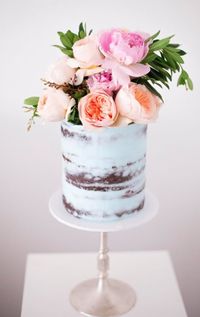 Love the explosion of flowers coming from the top of this gorgeous naked wedding cake!