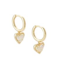 Hearts and huggies together - is there anything better? The Ari Heart Gold Huggie Earrings in Iridescent Drusy adds that little something extra to your look with its playful asymmetrical design. Metal 14k Yellow Gold Over Brass Material Iridescent Drusy Closure Hinge Size 0.60” outside diameter, 0.43” L 0.40” W charm Please note: Due to the one-of-a-kind nature of the medium, exact colors and patterns may vary slightly from the image shown. | Kendra Scott Ari Heart Gold Huggie Earrings in Irides