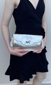 Introducing our latest addition to the collection - a stunning metallic gold leather clutch with a beautiful horse embellishment. Handmade with love, this unique piece is perfect for weddings, parties, Christmas eve or new years eve. Whether you're a bride or bridesmaid, this clutch will add a touch of elegance to your outfit. Don't miss out on this must-have accessory! its also a perfect fitcto a Kentucky Derby event, justcthe right size! This beautiful clutch is handmade from genuine gold leat