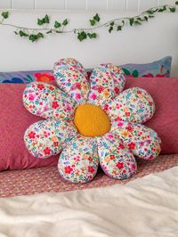 Upgrade a boring seat cover to our cute, flower-shaped cushion! Plop it on a wooden chair before you sit at your desk and immediately feel the comfort, and you can also fold it in half for additional back support! It's great as a floor cushion or bed pillow that brings a pop of color to any room. And even better, it's REVERSIBLE, so you can change up the look of your set up whenever you want, from a flower and vine print on white petals to a purple-pink floral border design. Grab extras to have