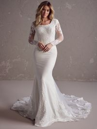 Turn heads in this elegant Felicia Leigh temple ready wedding gown by Rebecca Ingram dress. Crafted from Sherwood crepe, the gown is adorned with sequin lace motifs on the bodice, modest scoop neck, fitted long illusion lace sleeves, and extended illusion lace train. Comfortably lined with Vlada stretch jersey. Estimated Delivery Time: 18-22 Weeks. Rush options may be available. ONLINE ONLY Once an order is placed we are unable to do any returns or exchanges due to the nature of the bridal and f