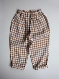 Our classic gingham trouser is a daily wardrobe style staple made from delightfully soft and durable organic linen. With a relaxed, comfortable fit that provides ample room for free-spirited movement and play, it features an adjustable, elasticated waistband to keep them snug. We just love this trouser with The Essenti