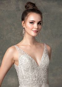 The Haven wedding dress has a v-neckline with floral bead work on bodice, A-line silhouette with layers of nude and sparkle tulle. #weddingdress #bridal #bridalgown #weddinggown #alineweddingdress #tulleweddingdress #sparkle #sparkletulle #handbeaded